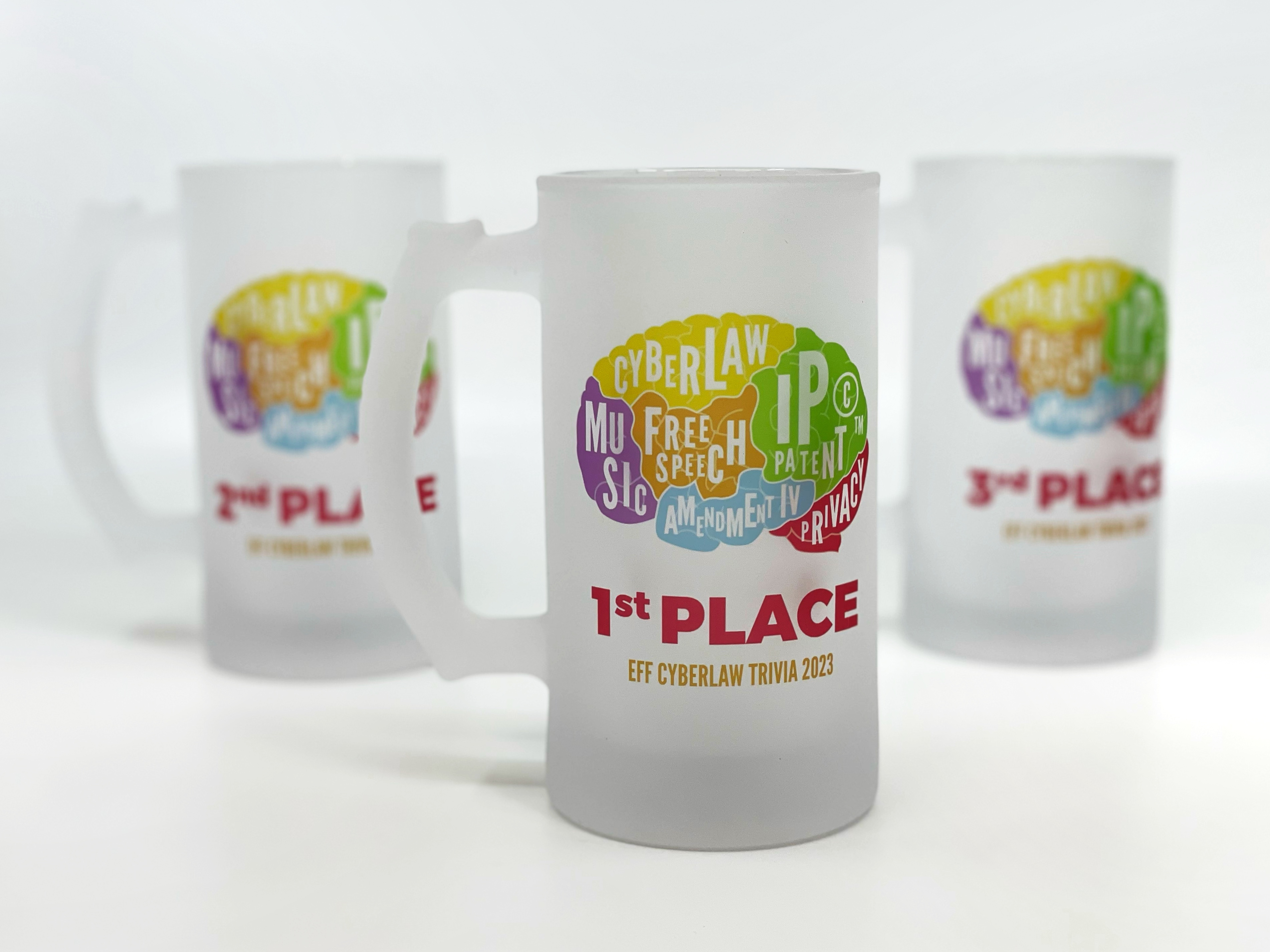 Three EFF steins featuring the Cyberlaw Trivia brain logo. Front stein is first place, then second to the left, and third to the right.