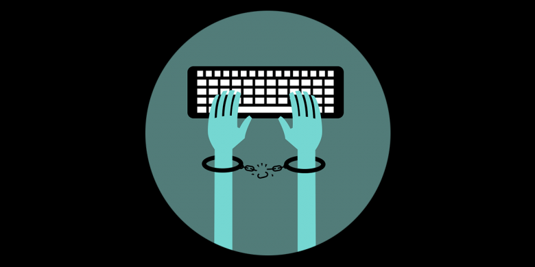 shackled hands above a keyboard