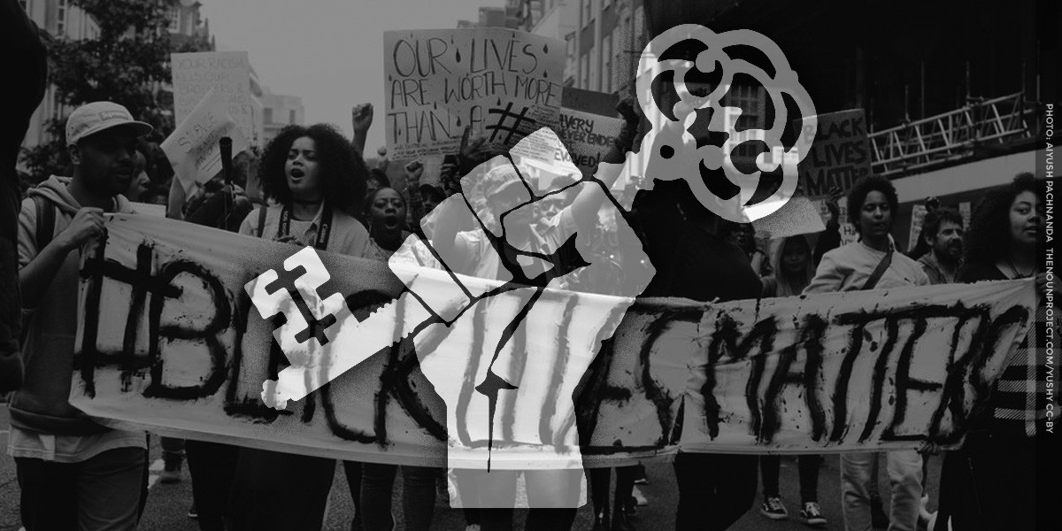 fist with key icon over BLM protest photo