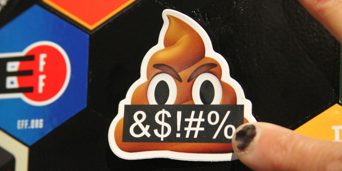 Sticker of an angry poop emoji, black banner reads "&$!#%"