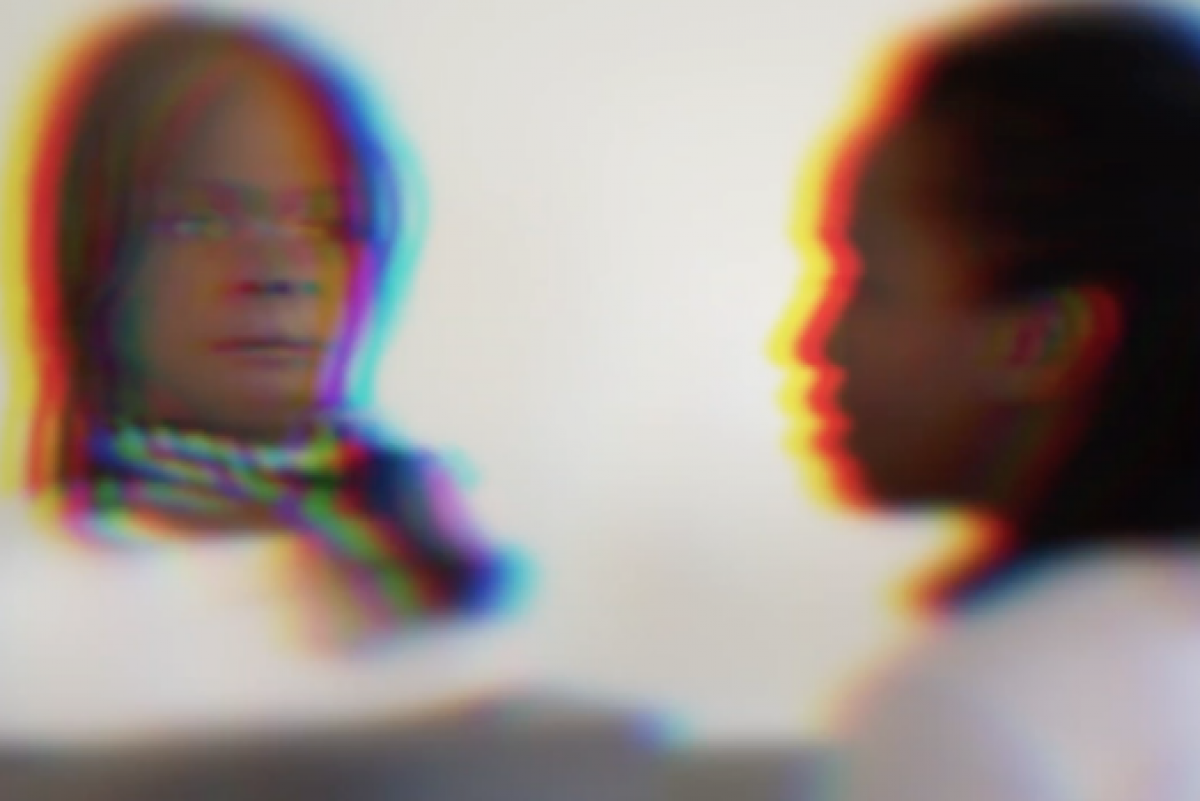 Distorted image of what appears to be a person looking into a mirror. However, instead of their image what appears to be a human-like robot is reflected. 