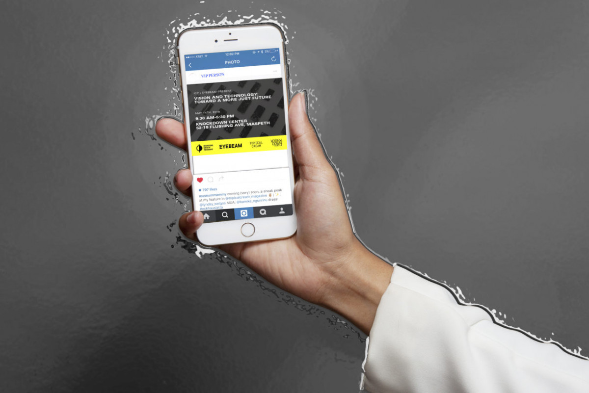 Over a gray background, a hand holds a mobile device displaying event details for Vision and Technology: Toward a More Just Future
