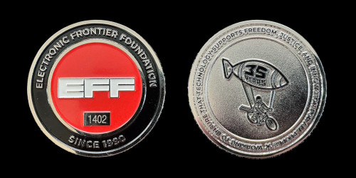 Front and back of silver EFF 35th anniversary challenge coin on a black background