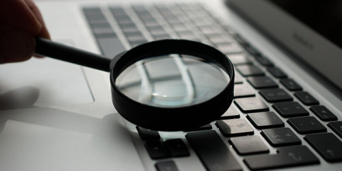 a keyboard being viewed through a magnifying glass