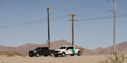A truck with a mobile surveillance tower next to a Border Patrol vehicle